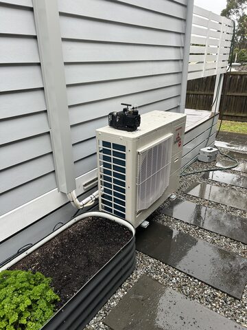 Split system outdoor unit installed against a Mitcham home