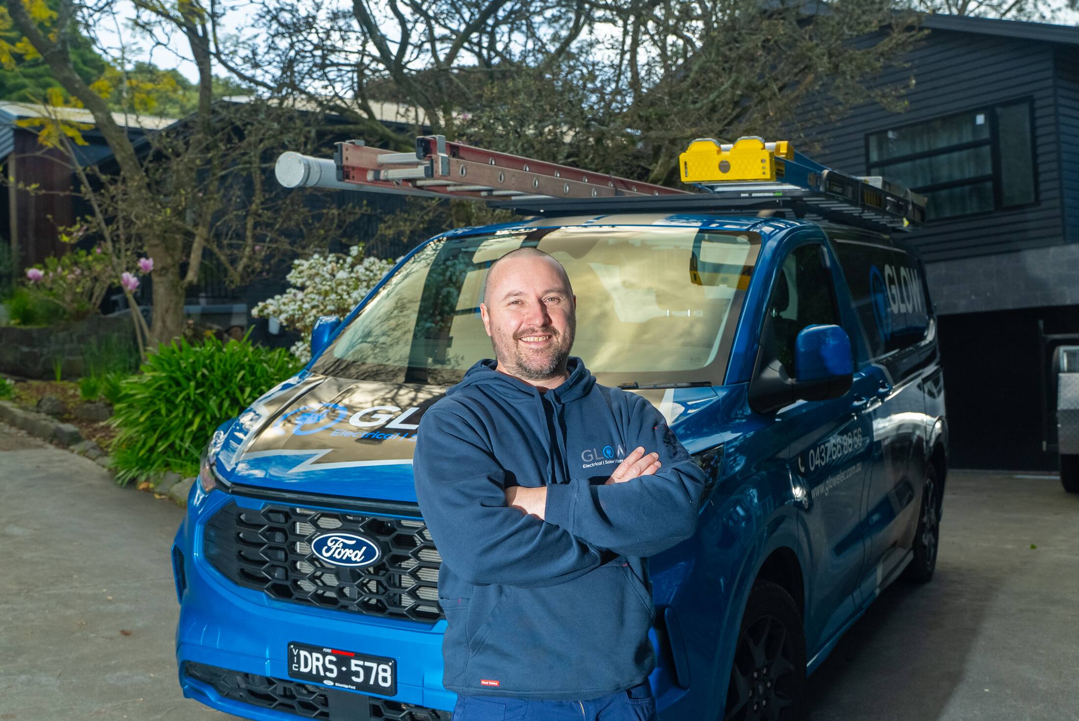 Michael from Glow Electrical on a residential driveway