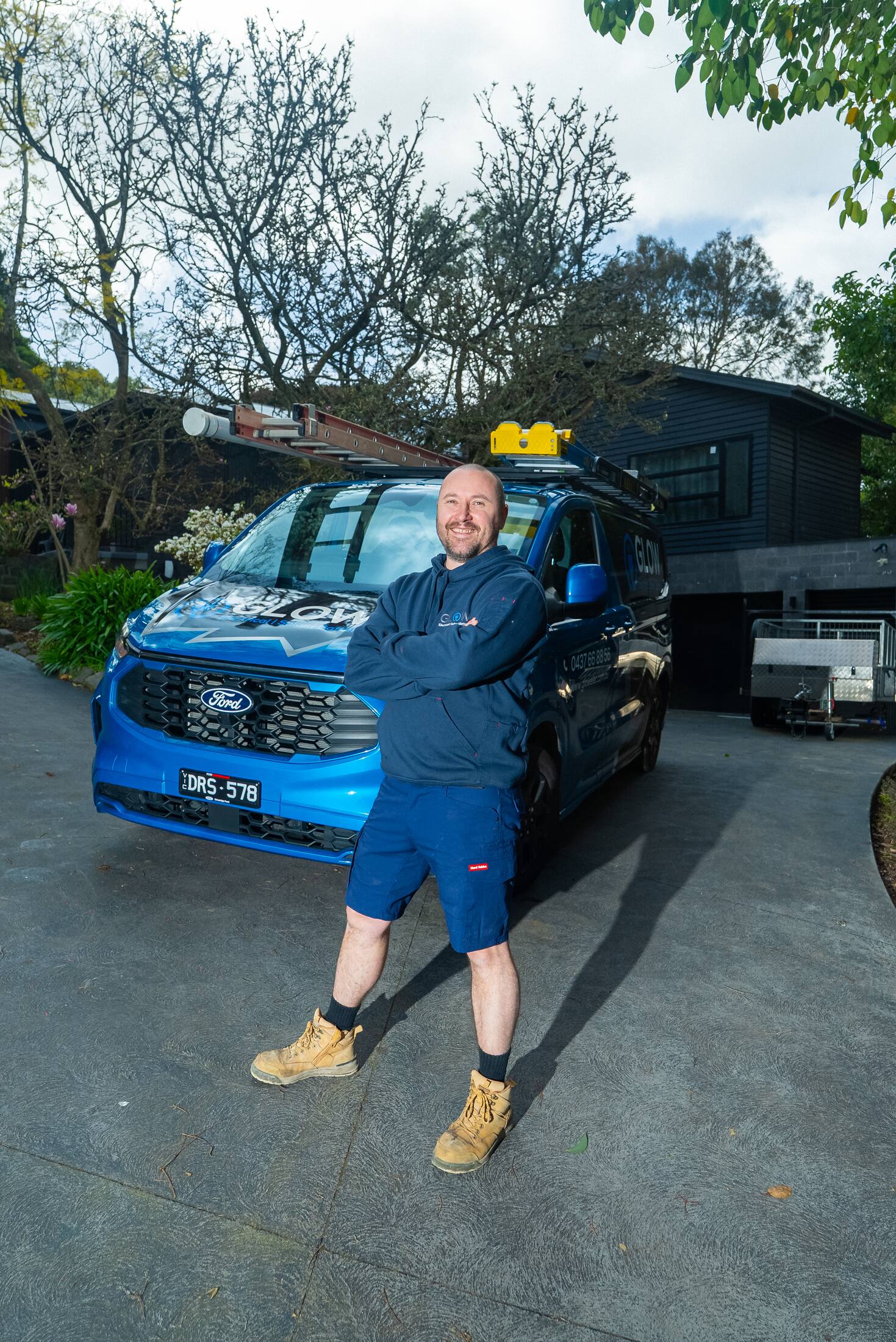 Michael beside the Glow van on a residential driveway