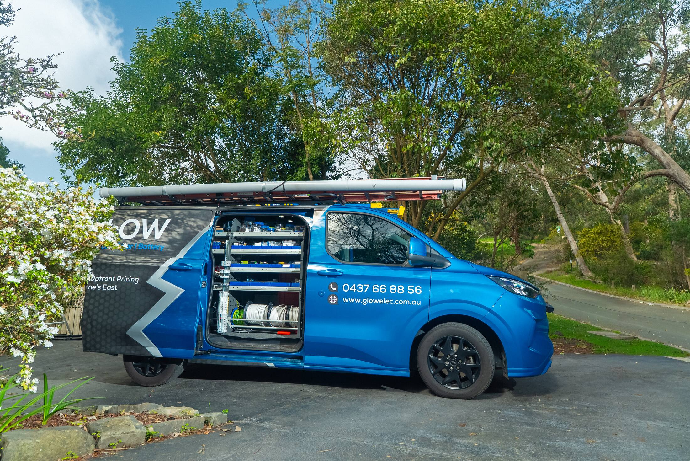 The Glow van with the side door open, fully stocked
