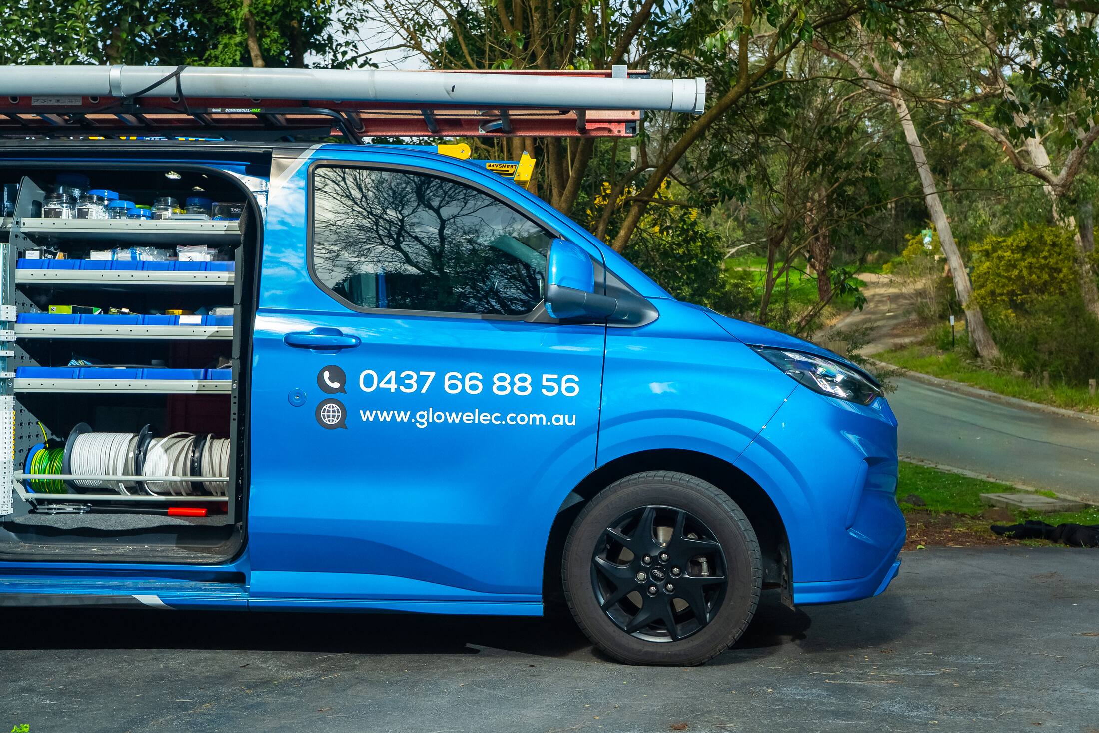 Van shelving stocked with cable and switchgear for an EV charger install