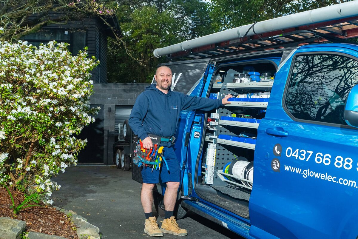 Michael at the open van door with his tool belt on