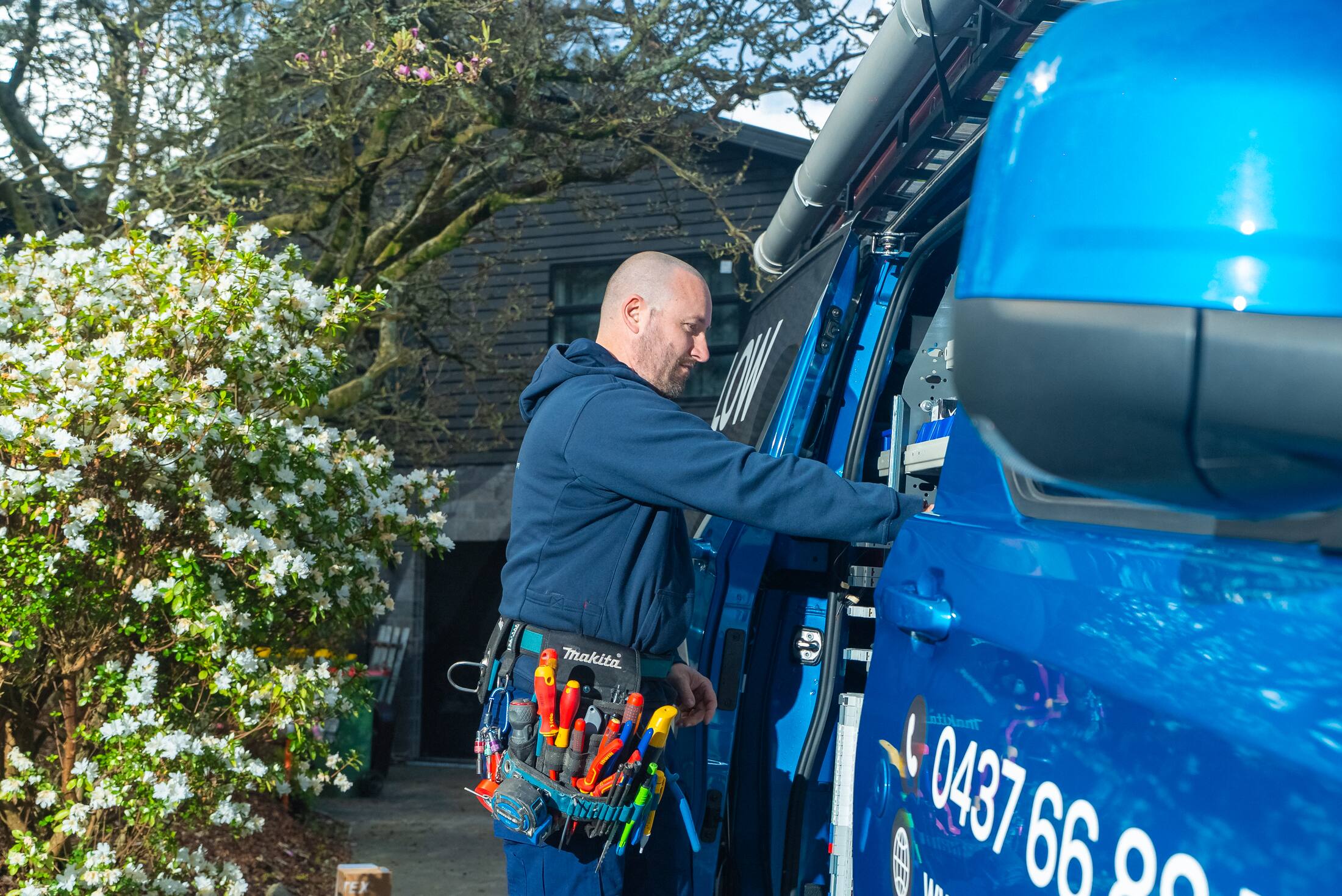 Michael reaching into the van for a tool on a fault finding call